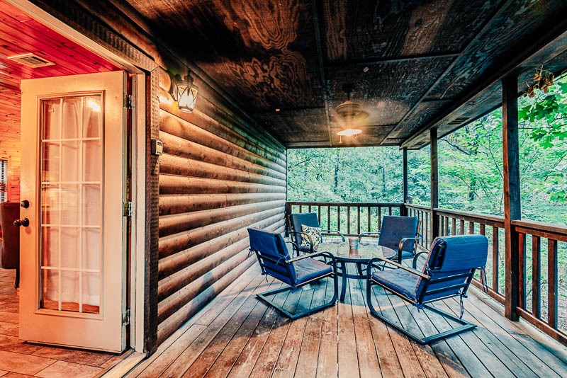 cabin back porch with seating for four people